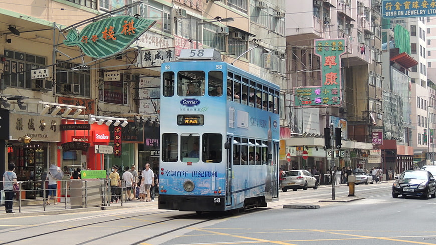 Blue Double-Decker Tram on Busy Hong Kong Street