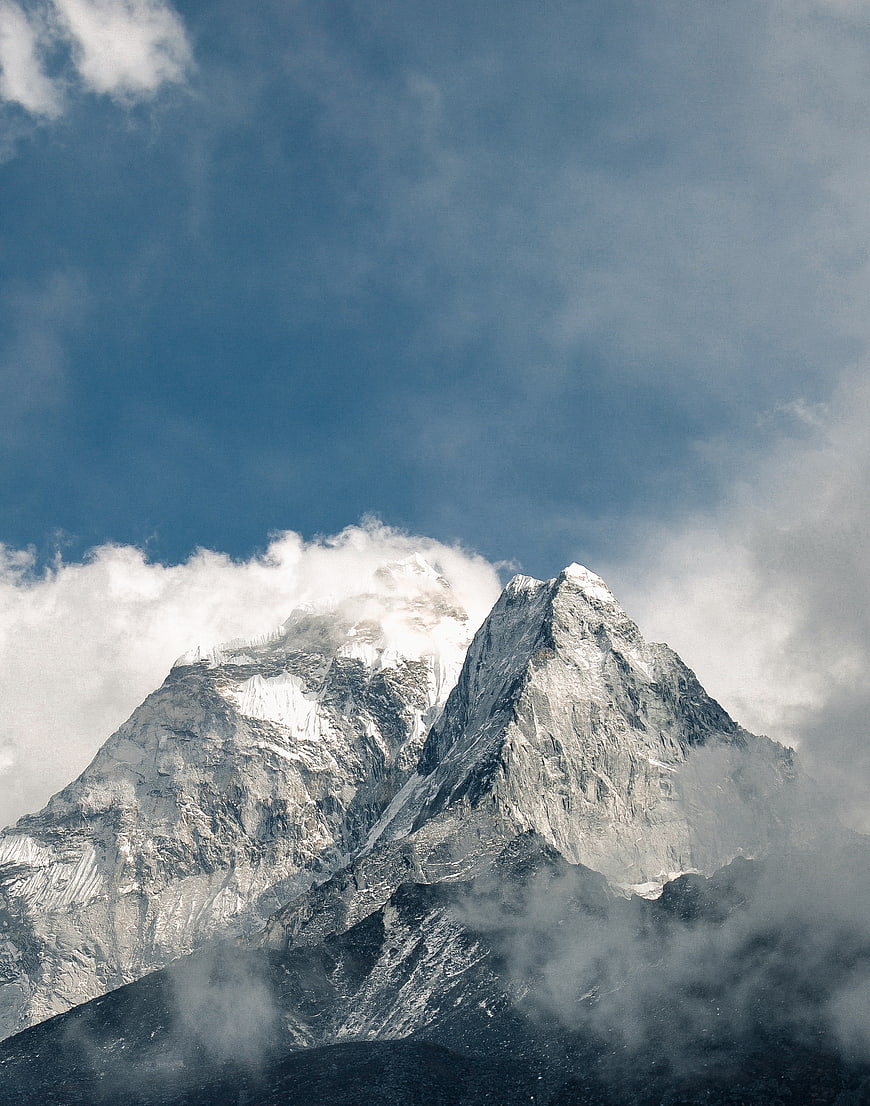 Majestic Snow-Capped Mountain Peak with Clouds