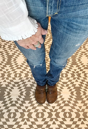 Woman in Jeans and Boots on Patterned Floor