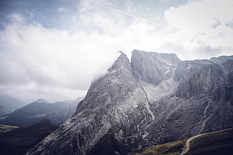 Majestic Rocky Mountain Peak with Clouds and Winding Path