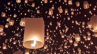 Illuminated Sky Lanterns Floating in Dark Night Sky