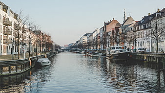 Scenic European Canal with Boats and Historic Architecture