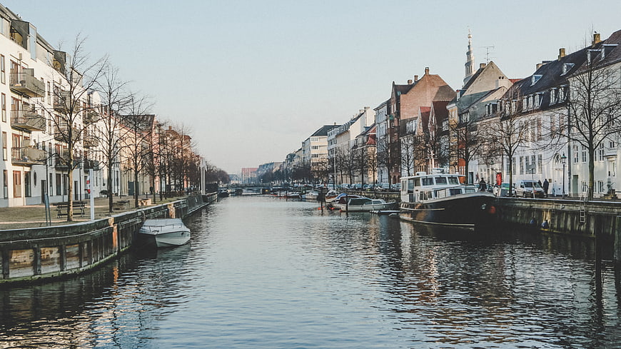 Scenic European Canal with Boats and Historic Architecture