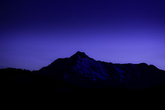 Silhouette of Mountain Peak Against Purple Twilight Sky