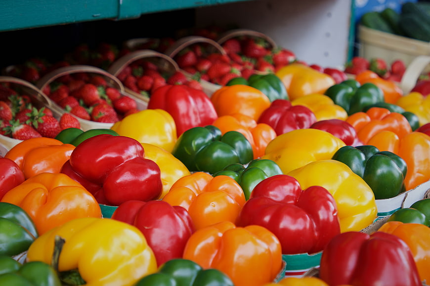 Colorful Bell Peppers and Strawberries at Farmers Market