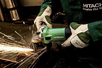 Worker Using Green Hitachi Angle Grinder with Sparks