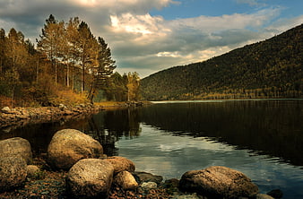 Autumn Lake Landscape With Boulders And Forested Hills