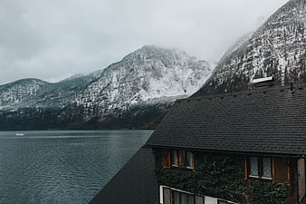 Snowy Mountain Lake View with Traditional Alpine House