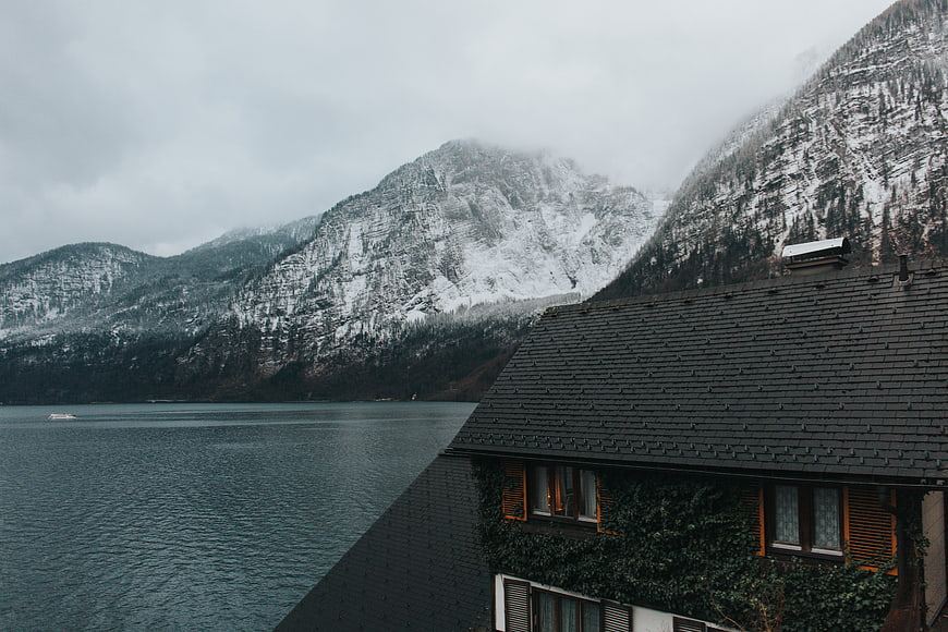 Snowy Mountain Lake View with Traditional Alpine House
