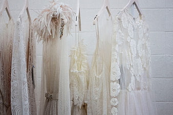 Vintage Lace Wedding Dresses Hanging on Hangers