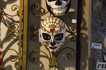 Venetian carnival masks on ornate golden gate