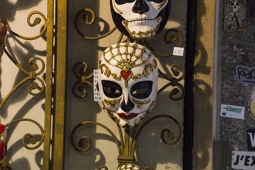 Venetian carnival masks on ornate golden gate