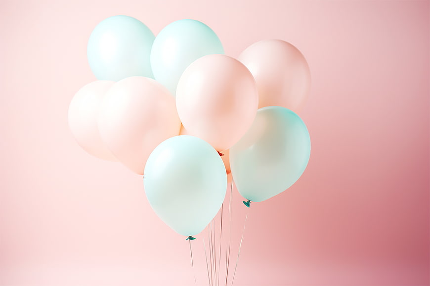 Pastel pink and blue balloons on a soft pink background
