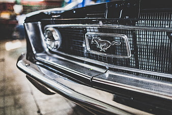 Close-up of classic black Mustang front grille and emblem