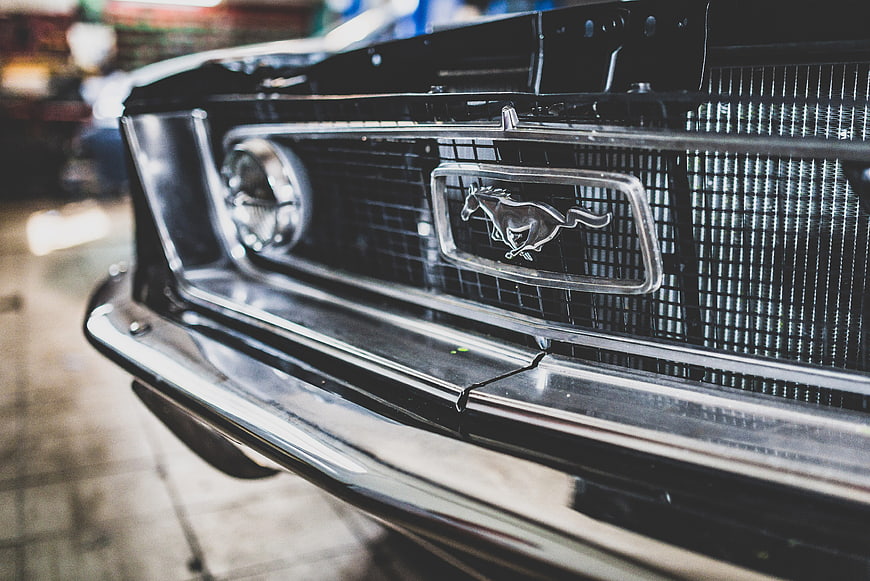 Close-up of classic black Mustang front grille and emblem