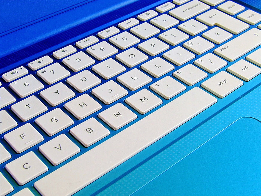 Close-up of Blue Laptop Keyboard with White Keys
