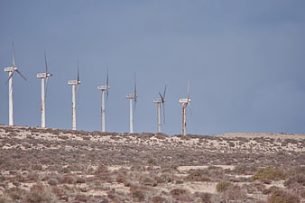 Row of Rusty Wind Turbines on Desert Hilltop