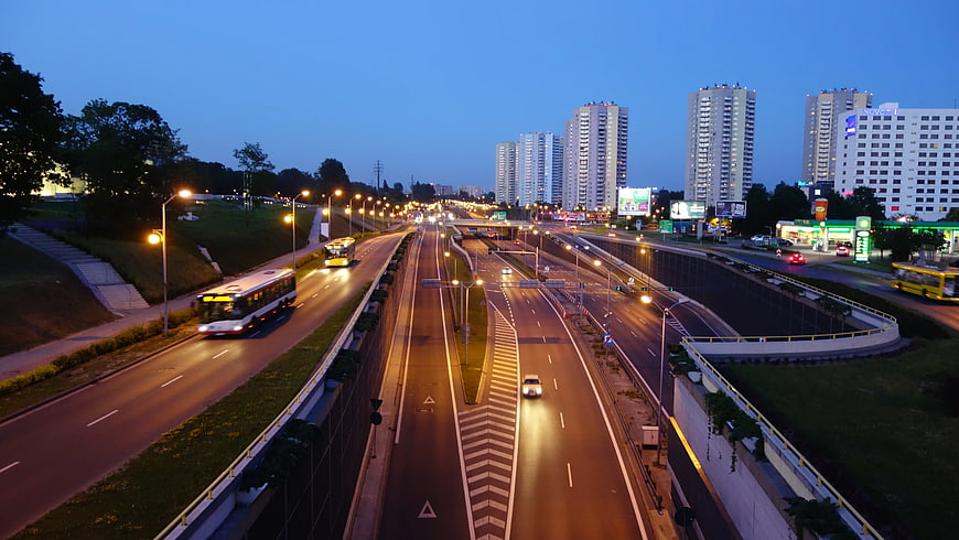 City Highway Traffic at Dusk with Buses and Skyscrapers