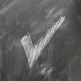 White Chalk Checkmark On Textured Blackboard Surface