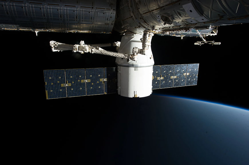 Spacecraft Docked at International Space Station Over Earth