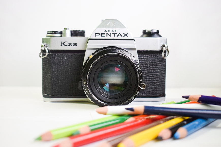 Vintage Pentax K1000 Camera with Colored Pencils