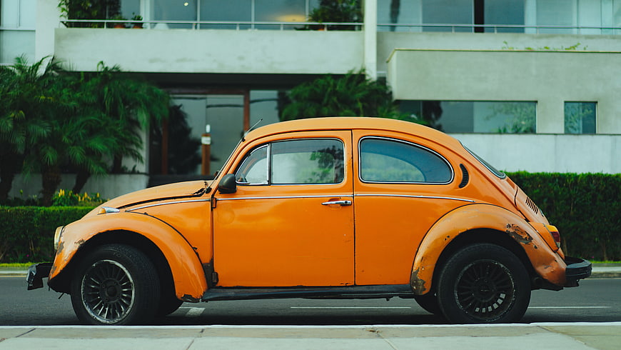 Vintage Orange Volkswagen Beetle Parked on Street