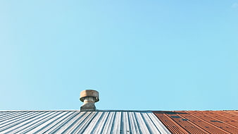 Rusty Roof Vent Against Clear Blue Sky