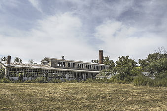Abandoned Industrial Factory Building with Overgrown Grass