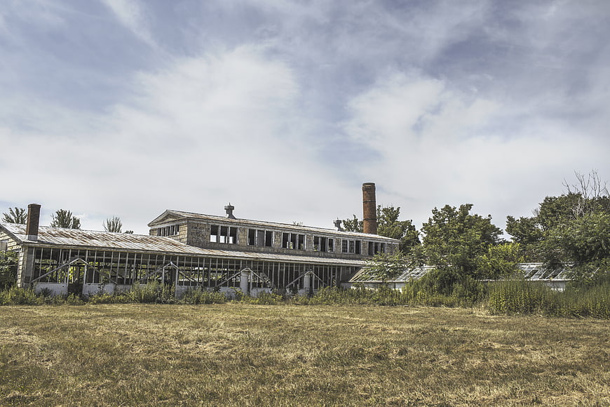 Abandoned Industrial Factory Building with Overgrown Grass