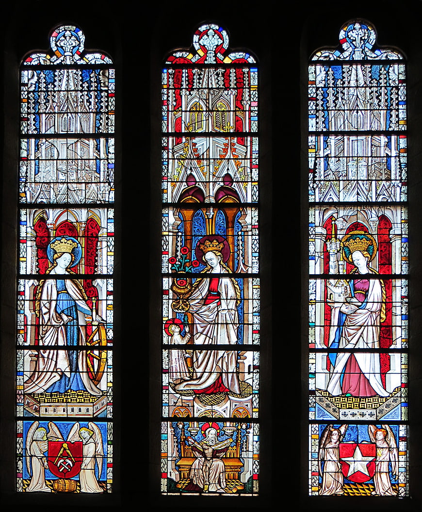 Gothic stained glass window depicting female saints and religious figures