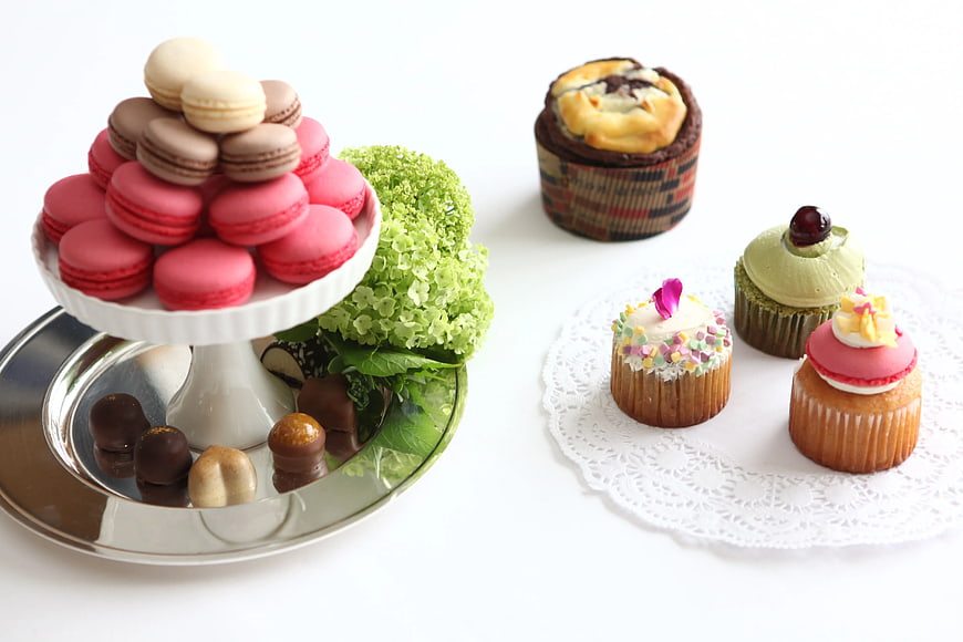 Assorted Macarons and Cupcakes on White Background