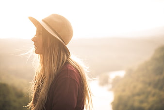 Woman in Hat Looking at Scenic Sunset View