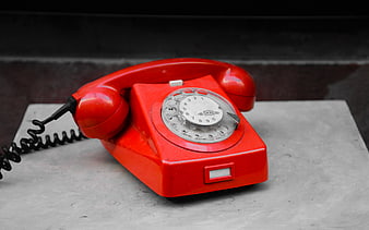 Vintage Red Rotary Dial Telephone on Concrete Surface