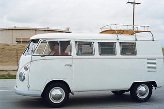 Vintage White Volkswagen T2 Bus Driving on Highway