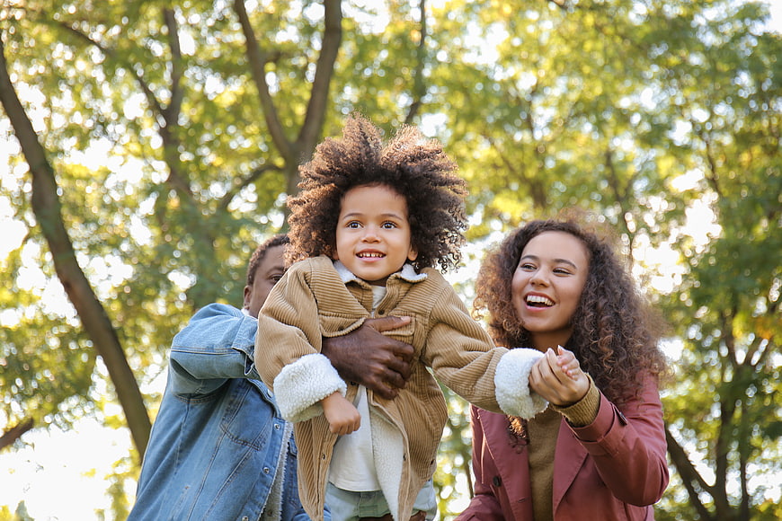 Happy African American Family Playing in Park