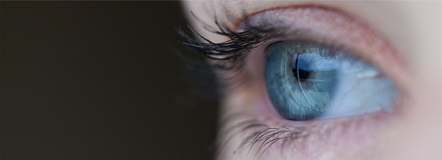 Close-up of a striking blue human eye with detailed iris texture