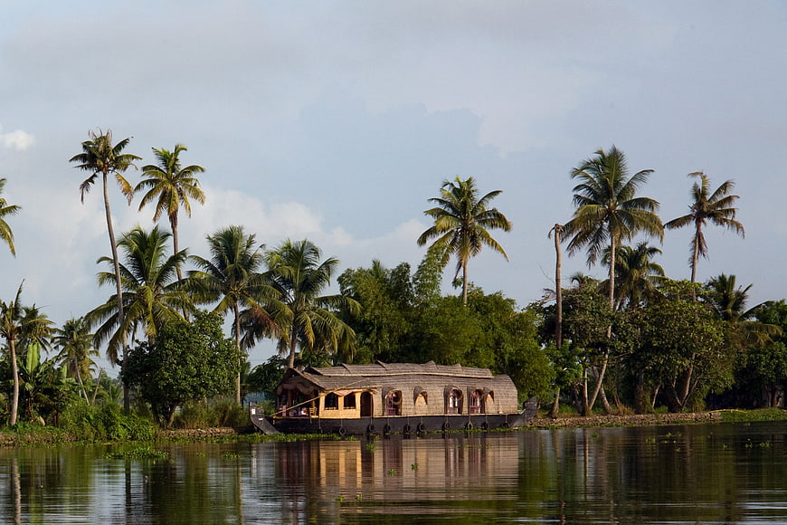 Traditional Houseboat Moored in Kerala Backwaters with Palm Trees