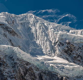 Majestic Snow-Capped Mountain Peak with Glaciers and Blue Sky