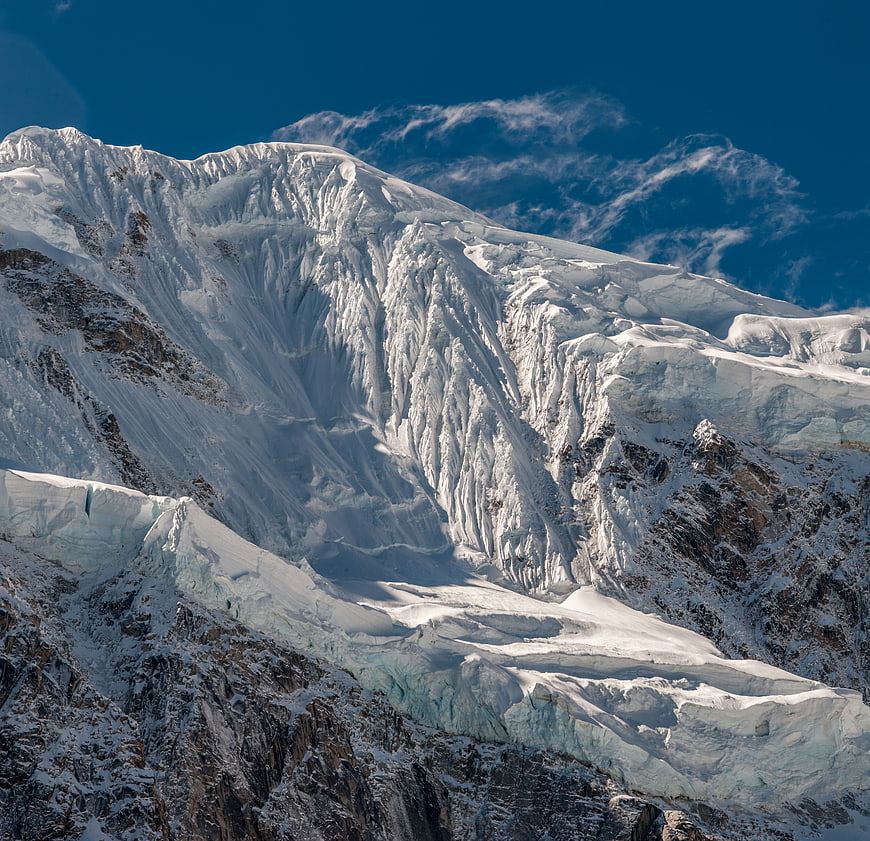 Majestic Snow-Capped Mountain Peak with Glaciers and Blue Sky