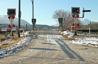 Rural Railroad Crossing With Snow And Mountain Background