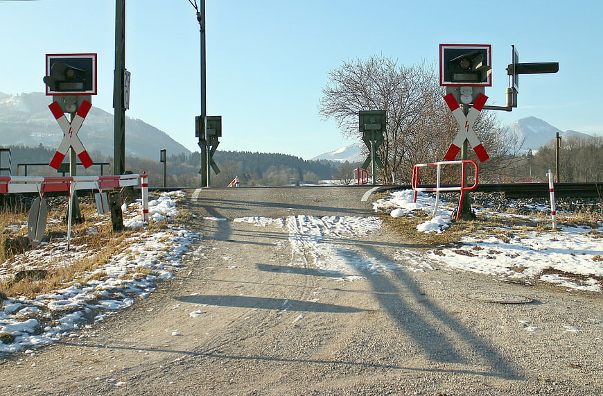 Rural Railroad Crossing With Snow And Mountain Background