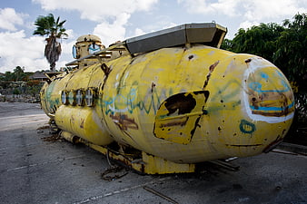 Abandoned yellow submarine with rust and graffiti