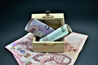 Thai Baht Banknotes In Small Wooden Treasure Chest