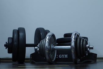 Chrome and Rubber Dumbbells on Gym Floor