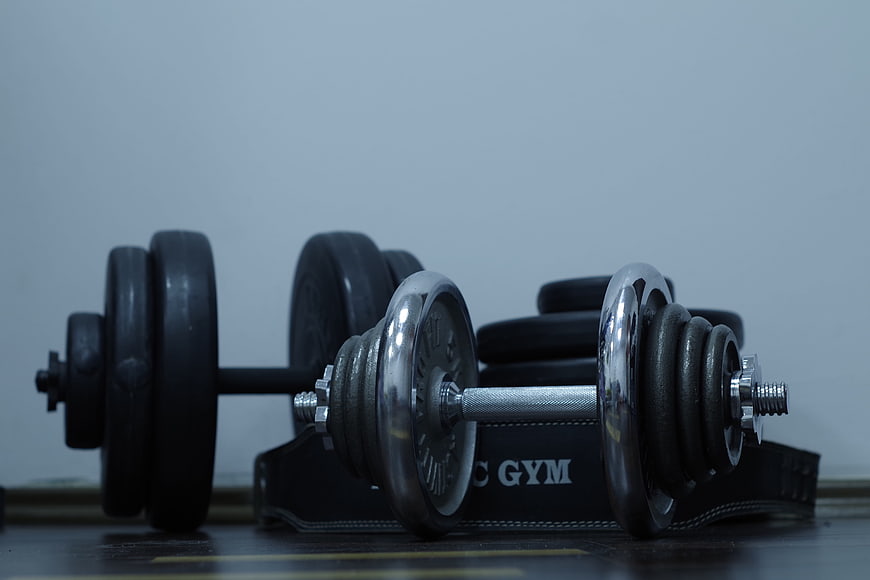 Chrome and Rubber Dumbbells on Gym Floor