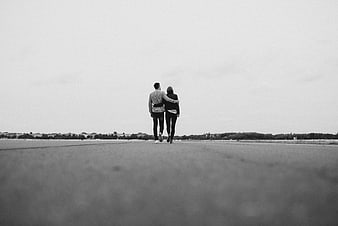 Couple Walking Away on Empty Road in Black and White