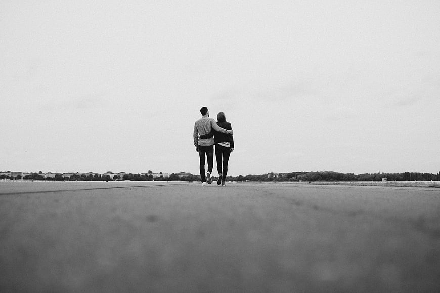 Couple Walking Away on Empty Road in Black and White