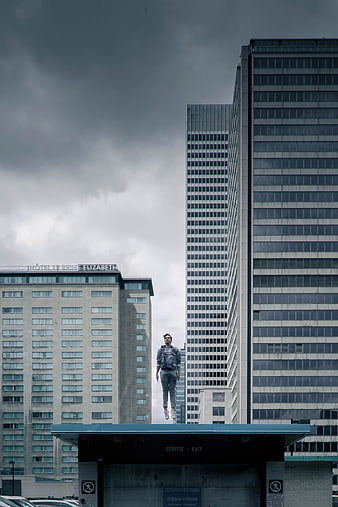 Man jumping in urban cityscape with skyscrapers