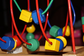 Close-up of colorful wooden bead maze toy with wires