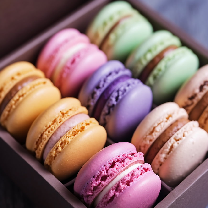 Colorful French macarons in a brown box